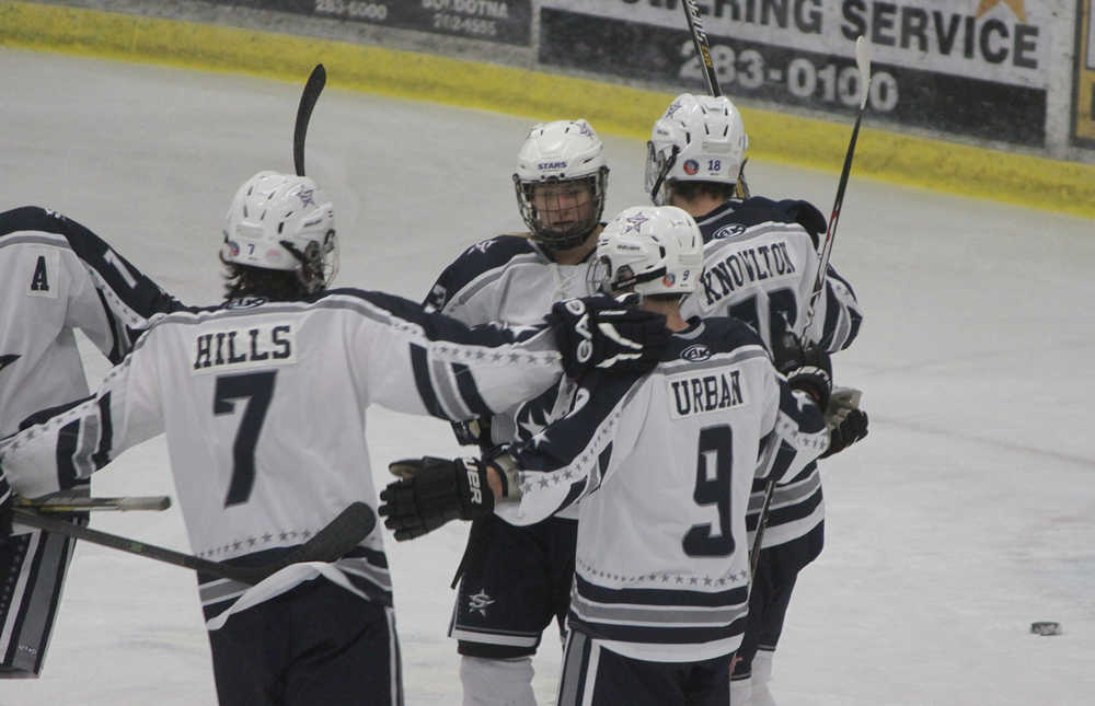 Photos by Joey Klecka/Peninsula Clarion Calvin HIlls, Jace Urban and Ethan Brown (facing forward) congratulate Cameron Knowlton on his first-period goal against Juneau-Douglas Thursday at the Soldotna Regional Sports Complex.