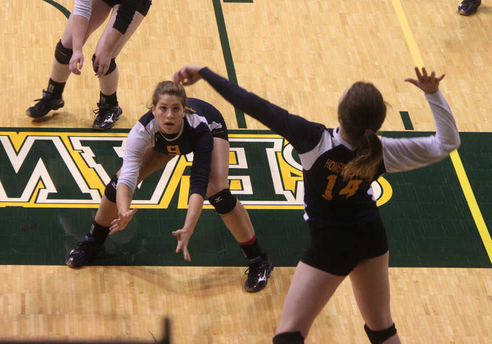 Photo by Joey Klecka/Peninsula Clarion Homer senior McKi Needham (9) watches as senior Paige Snyder (14) sets up a shot against Kotzebue, Friday at the Class 3A state volleyball tournament at the Alaska Airlines Arena in Anchorage.