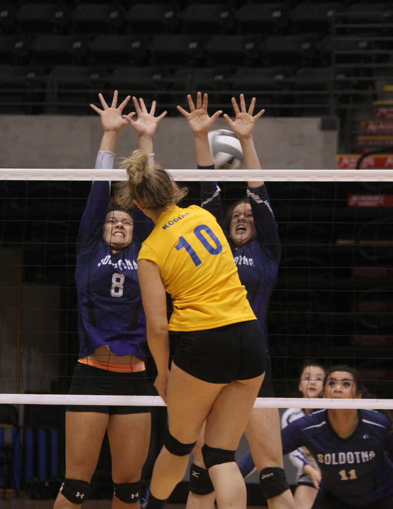 Photo by Joey Klecka/Peninsula Clarion Soldotna senior Lindsey Wong (8) and junior Judah Aley block a shot by Kodiak senior Richelle Walker (10) Friday at the Class 4A state volleyball tournament at the Alaska Airlines Arena in Anchorage.
