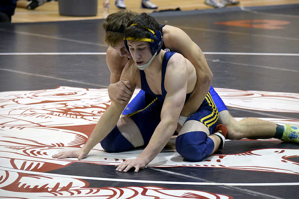 Photo by Rashah McChesney/Peninsula Clarion Homer's Tristen Cook starts on the ground during the 2015 Peninsula Duals on Friday Nov. 13, 2015 in Nikiski, Alaska.