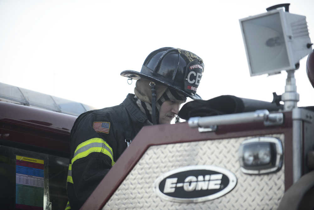 Photo by Megan Pacer/Peninsula Clarion Central Emergency Services Firefighter Matt Seizys works on one of the organization's engines during a practice drill on Tuesday, Nov. 17, 2015 at the CES station on Kalifornsky Beach Road. He and other firefighters have been training for about two months for an engineering test coming up on Nov. 19.