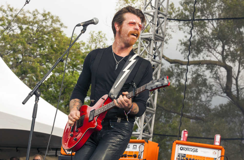 FILE - In this Sept. 11, 2015 file photo, Jesse Hughes of Eagles of Death Metal performs at Riot Fest & Carnival in Douglas Park in Chicago.  Hughes was scheduled to perform, Friday, Nov. 13, 2015, with the band at the Bataclan concert hall in Paris where patrons were taken hostage. The band says they are home safe after the Paris attacks, but they "are horrified and still trying to come to terms with what happened in France." The band released a new album last month and was on an European tour when the attacks occurred. They said all shows are on hold until further notice. (Photo by Barry Brecheisen/Invision/AP, File)