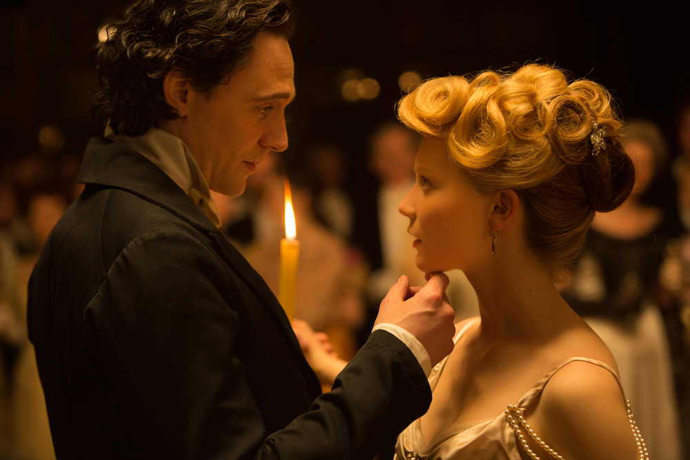 In this image released by Legendary Pictures and Universal Pictures, Tom Hiddleston, left, and Mia Wasikowska appear in a scene from "Crimson Peak." (Kerry Hayes/Legendary Pictures and Universal Pictures via AP)