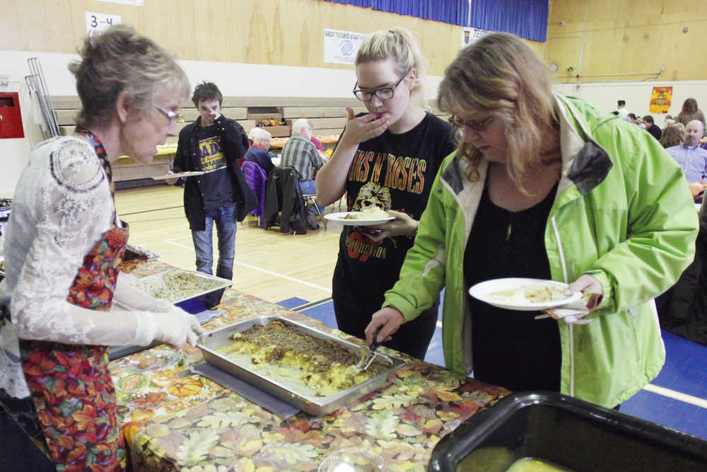 Photo by Kelly Sullivan/ Peninsula Clarion Susie Byrne serves student Christa McGahan and her mother Bobbie at the Kenai Alternative's Thanksgiving lunch Tuesday, Nov. 17, 2015, at Kenai Altnerative High School in Kenai, Alaska.