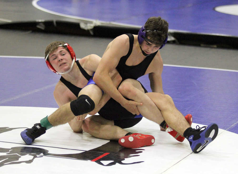 Soldotna's Seth Hutchison battles Wasilla's Isaiah Elvsaas in a 126-pound match of the semifinal round of the Lancer Smith Memorial wrestling tournament Nov. 20 at Palmer High School. Hutchison scored a 10-0 major decision win.