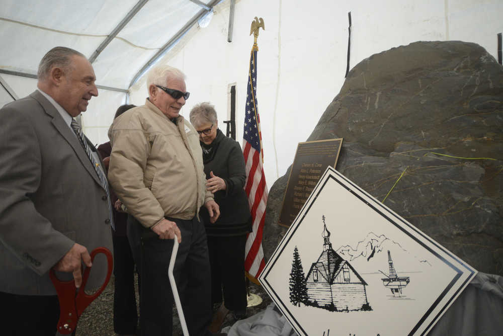 Photo by Megan Pacer/Peninsula Clarion From left to right: former Kenai Mayor John Williams, Kenai Charter Commission member Richard Morgan and Kenai Mayor Pat Porter present a rock affixed with a memorial plaque on Sunday, Nov. 29, 2015 outside City Hall in Kenai, Alaska. The rock was dedicated to honor the commission members who signed Kenai's charter in 1963.