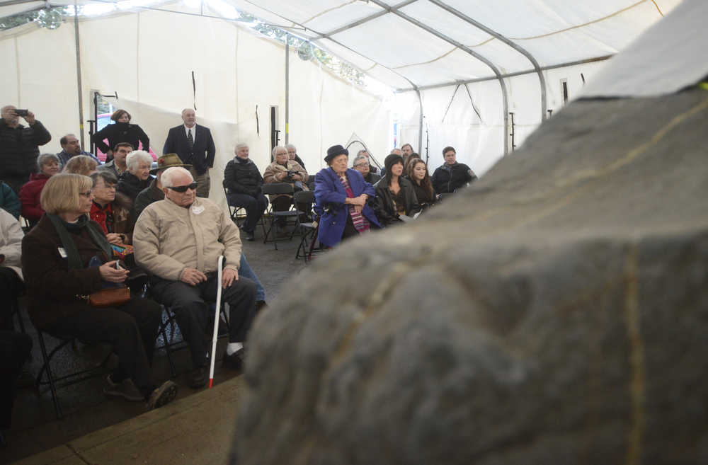 Photo by Megan Pacer/Peninsula Clarion Richard Morgan, center, awaits the start of a dedication ceremony to honor members of Kenai's Charter Commission on Sunday, Nov. 29, 2015 in front of City Hall in Kenai, Alaska. Morgan, the last living member of that commission, was asked to cut the Cornerstone Rock's ceremonial ribbon.