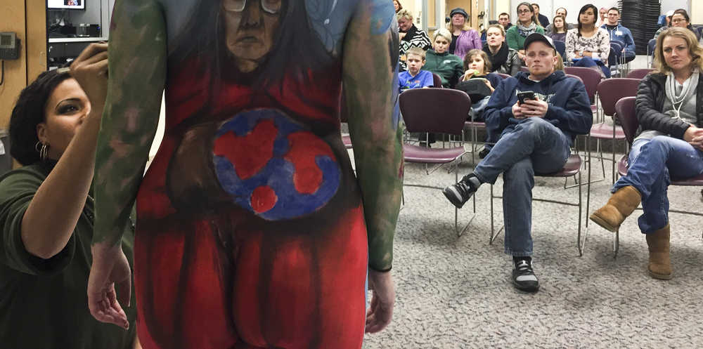 Photo by Rashah McChesney/Peninsula Clarion Angela Rene Roberts, the 2014 U.S. National Makeup Artist of the Year, works on a mural during a live body painting presentation on Wednesday Dec. 1, 2015 at Kenai Peninsula College - Kenai River Campus in Soldotna, Alaska. Roberts spent about two hours putting the finishing touches for a classroom of anatomy and physiology students - and curious members of the public. The piece took about four hours to complete.