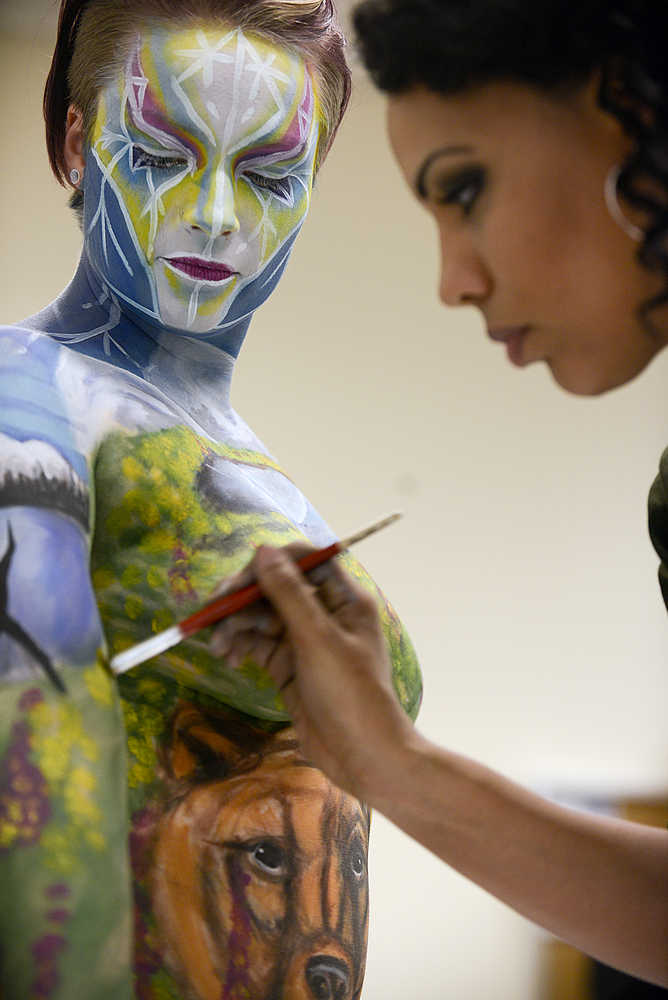 Photo by Rashah McChesney/Peninsula Clarion Sara Christensen gets painted by the 2014 U.S. National Makeup Artist of the Year, Angela Rene Roberts, during a live body painting presentation on Tuesday Dec. 1, 2015 at Kenai Peninsula College - Kenai River Campus, in Soldotna, Alaska.