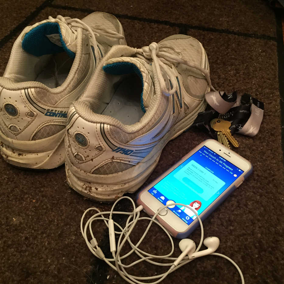 This Wednesday, Oct. 28, 2015 photo shows sneakers, headphones, house keys and a cellphone displaying the Couch to 5K app - all the gear a jogger needs to head out for a run. The Couch to 5K app offers gentle guidance for novice runners looking to go from being a couch potato to being able to run 5 kilometers.  (AP Photo/Beth J. Harpaz)