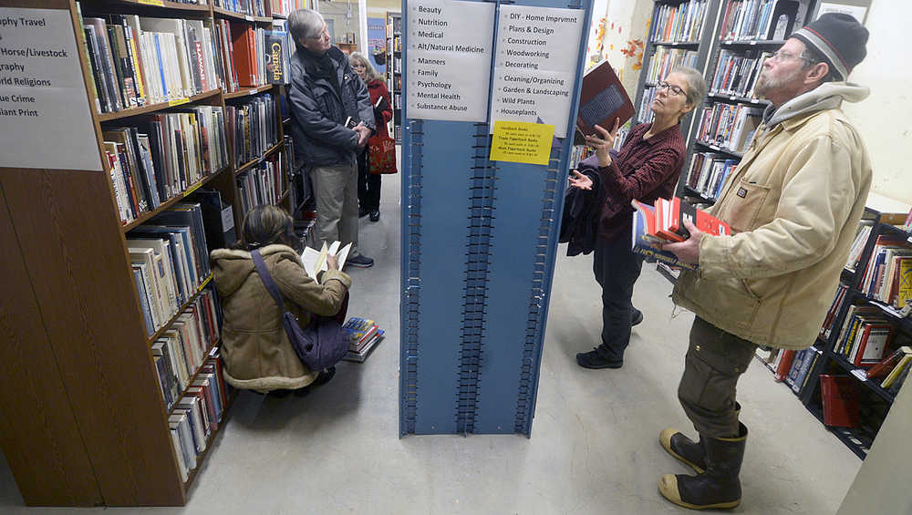 Photo by Rashah McChesney/Peninsula Clarion Several people flip through books during the the Soldotna Public Library's book sale in the basement of the library on Thursday Dec. 3, 2015 in Soldotna, Alaska.  More than 80 community members had stopped into the sale by 4:30 p.m.