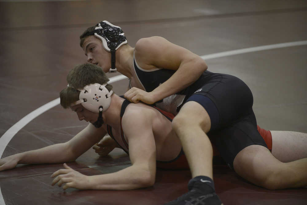 Photo by Joey Klecka/Peninsula Clarion Nikiski's Nathan Carstens wrestles with Houston's Noah Plumb in the 170-pound match in the fifth-place dual at Saturday's North-South Duals tournament at Soldotna Prep.