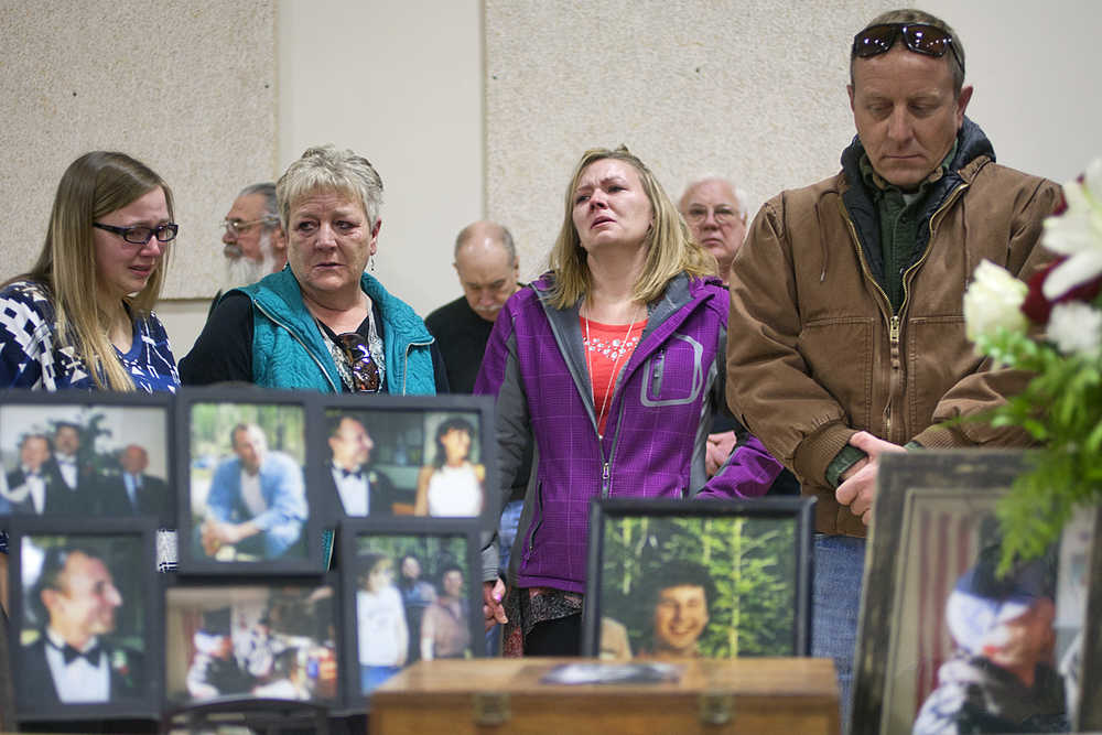 Photo by Rashah McChesney/Peninsula Clarion  Madison Skornik, of Anchorage, Marti Delimont, of Anchorage, Stephanie Huber, of Anchorage and  Kent Ployhar, of Mexico mourn the loss of Sterling resident Jon Ployhar during a memorial on Sunday Dec. 6, 2015 in Sterling, Alaska. Skornik and Huber are Jon Ployhar's neices, while Huber and Kent Ployhar are his siblings. Jon Ployhar was killed during a confrontation with an Alaska State Trooper in October.