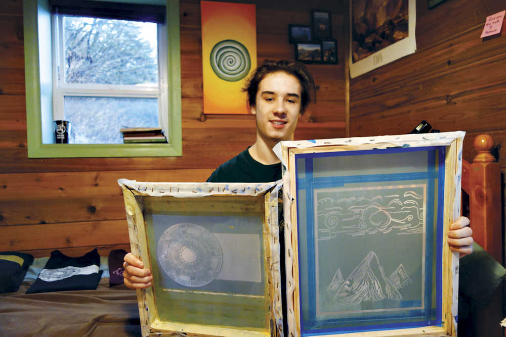 ADVANCE FOR WEEKEND DEC. 12-13, 2015 AND THEREAFTER - In this Nov. 27, 2015 photo, Juneau-Douglas High School student Noah Spengler holds up two of his silk-screens at his home in Juneau, Alaska. Spengler is a 17-year-old with a business he's created by hand. Spengler paints and draws, keeps sketches in a notebook and paintings on the walls of his family's home. Earlier this year, he found a way to get his artwork out into the world, and customers' closets, when he started a silk-screening business. And though it's just getting started, he's shipped t-shirts and sweatshirts with his designs as far as the United Kingdom and Australia. (Mary Catharine Martin/Capital City Weekly via AP)
