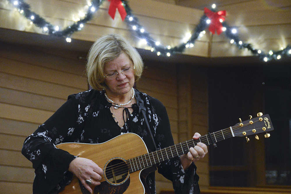 Photo by Megan Pacer/Peninsula Clarion Soldotna resident Gail Kennedy plays a song for a group of parents during the second annual Candlelight Remembrance Program on Sunday, Dec. 13, 2015 at the Christ Lutheran Church in Soldotna, Alaska. The local chapter of The Compassionate Friends hosts the event for parents whose children have died.