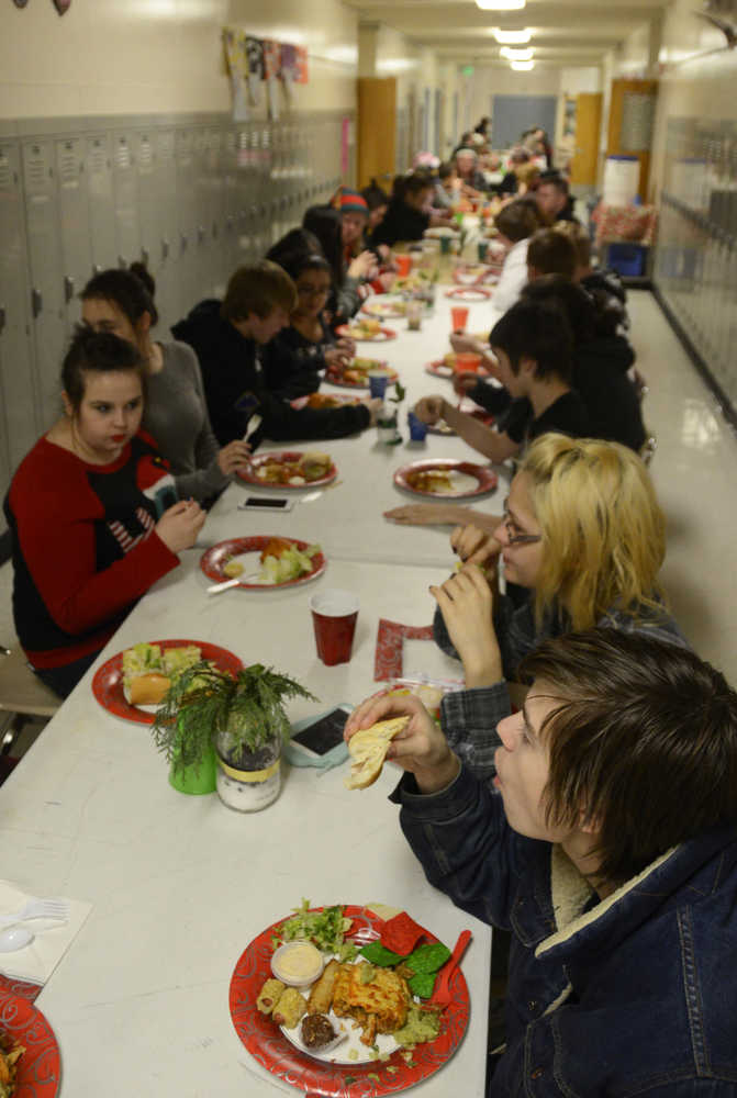 Photo by Megan Pacer/Peninsula Clarion Students and staff at Kenai Alternative High School enjoy the annual Grinch Day lunch on Thursday, Dec. 17, 2015 at the school in Kenai, Alaska. Students help set up the meal and cook some of the dishes before they are presented with gifts to send them off to their winter break.