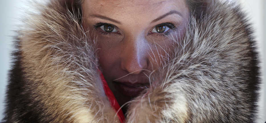 Pam Paquin poses with an "accidental fur" raccoon neck muff she created in Central Massachusetts, Wednesday, Nov. 18, 2015. Paquin's company, Petite Mort, uses roadkill fur harvested from animal carcasses culled with the help of highway departments and animal control officers. (AP Photo/Charles Krupa)