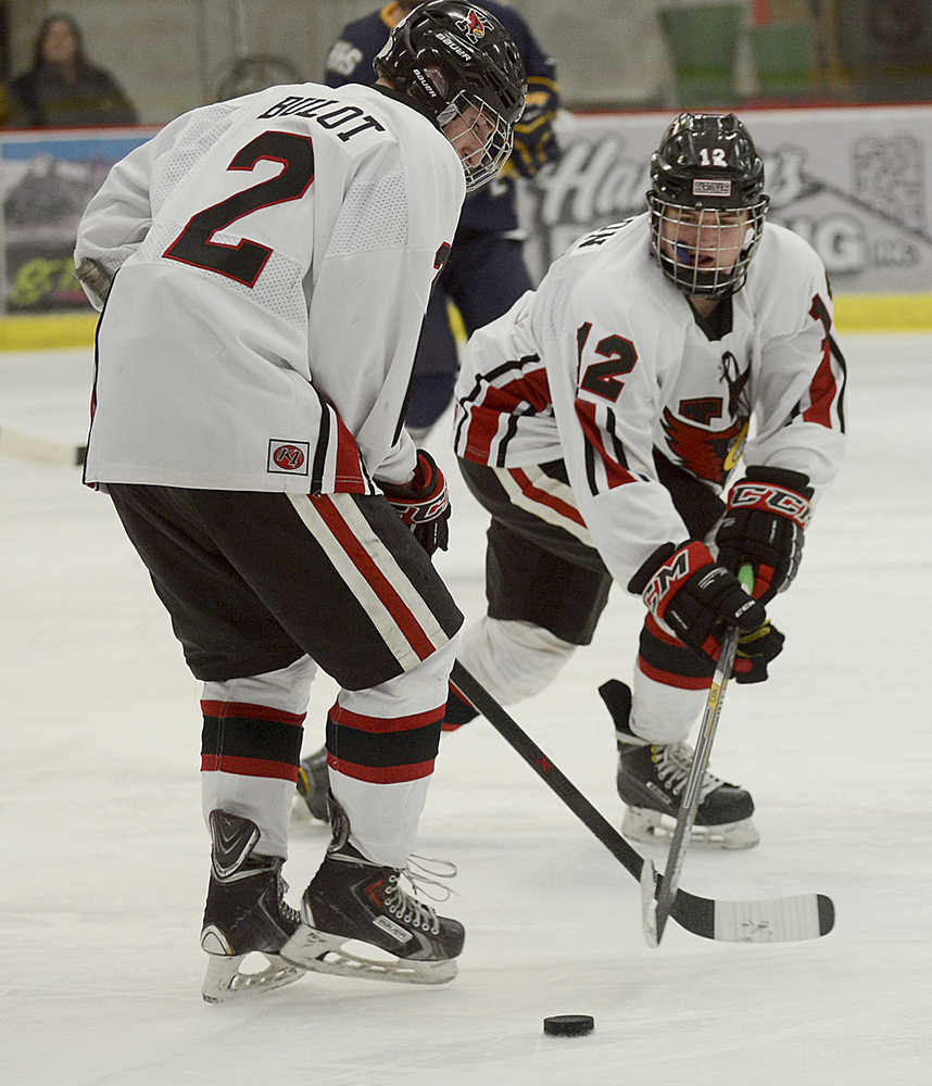 Photo by Rashah McChesney/Peninsula Clarion Kenai's Tristan Bulot and Bailey Maxson work for control of the puck during a game against the Homer Mariners on Thursday Dec. 17, 2015 in Soldotna, Alaska.