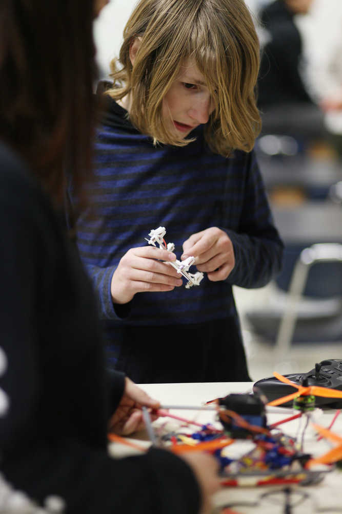 Photo by Kelly Sullivan/ Peninsula Clarion Seventh grader Brady Evoy tinkers with a few of his own Unmanned Aerial Vehicles Wednesday, Dec. 9, 2015, at Nikiski Middle-High School in Nikiski, Alaska. Evoy is not officially part of Alaska's Upward Bound "The Modern Blanket Toss" program, but attends most meetings because drone flying is a personal interest.