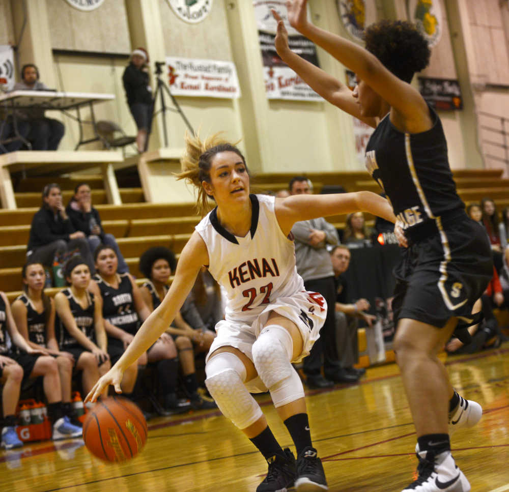 Ben Boettger/Peninsula Clarion Kenai's Alexis Baker attempts to get around South Anchorage's Nani Garner during a game on Friday, Dec. 18 at Kenai Central High School.