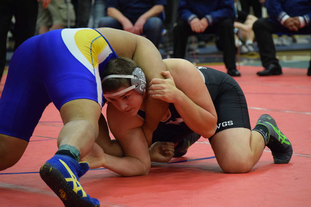 Photo by Joey Klecka Nikiski senior Luke Johnson looks for his next move against Barrow's Tua Mila in the 285-pound championship at the Class 1-2-3A state wrestling tournament at Bartlett High. The win was Johnson's third state crown.