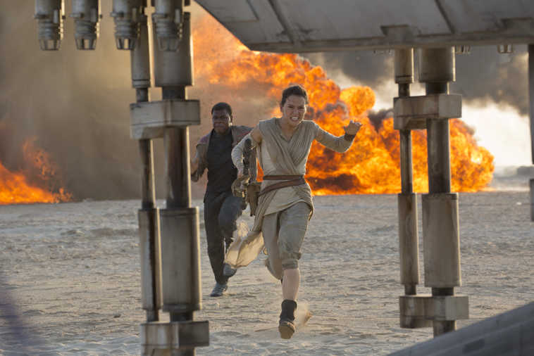 This photo provided by Disney/Lucasfilm shows Daisy Ridley, right, as Rey, and John Boyega as Finn, in a scene from the film, "Star Wars: The Force Awakens," directed by J.J. Abrams. The movie opens in U.S. theaters on Friday, Dec. 18, 2015. (David James/Disney/Lucasfilm via AP)