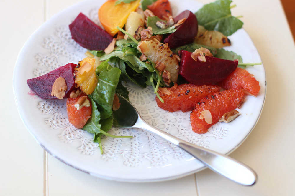 This Nov.  2, 2015 photo shows roasted beet and citrus salad in Concord, NH.  Add roasted beats and lightly charred citrus segments with nicely dressed greens for a robust salad. (AP Photo/Matthew Mead)