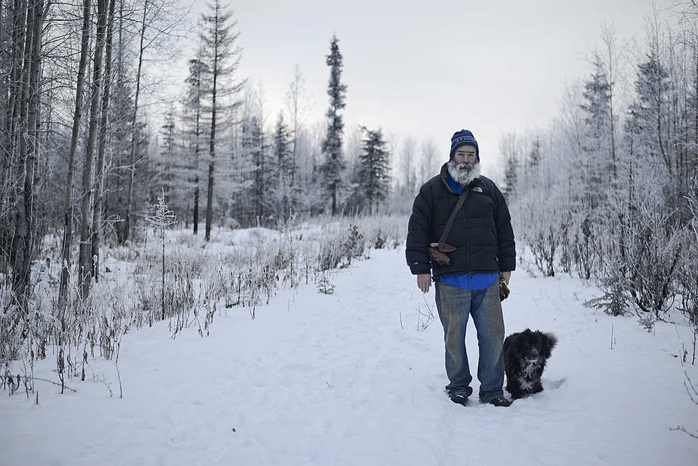 Photo by Rashah McChesney/Peninsula Clarion Ron Epperson, of Kasilof, takes a walk with his dog Smudge along the Woodcut Road near mile 6.5 of Funny River Road. Epperson said he's regularly hiked the road for nearly 40 years.