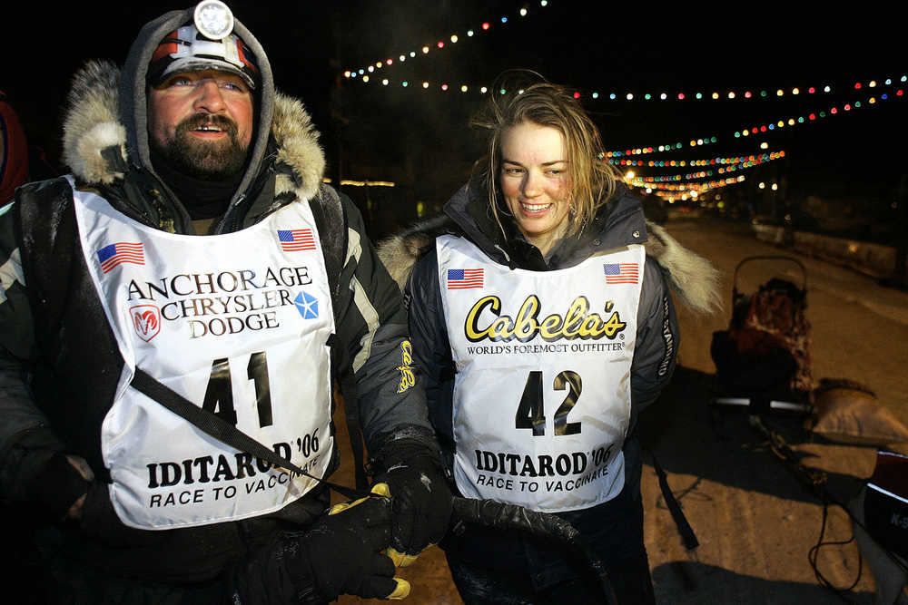 FILE - In this Saturday, March 18, 2006, file photo, Tim Osmar of Ninilchik, Alaska, left, who drove his dog team in front of  Rachael Scdoris, right, as her visual interpreter during the Iditarod Trial Sled Dog Race, stands with Scdoris at the finish in Nome, Alaska. Scdoris completed the race, placing 57th among 72 finishing teams, and the 10-year anniversary of her becoming the first legally blind musher to finish the Iditarod is just three months away. (AP Photo/Al Grillo, File)