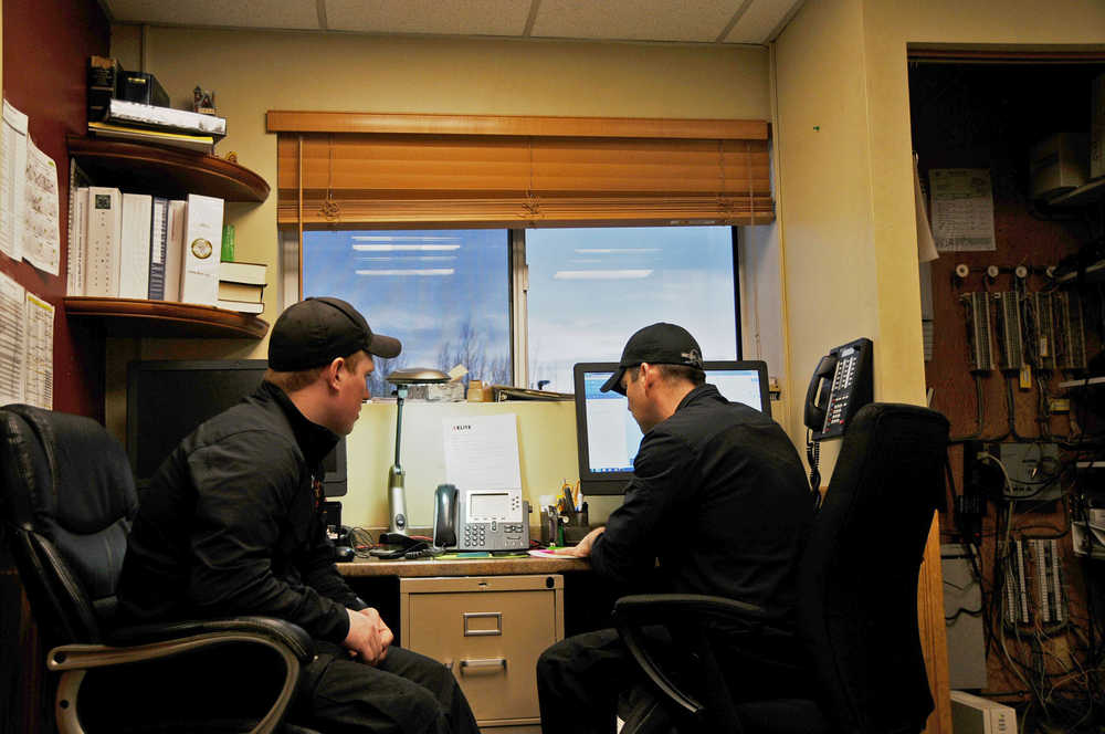 Photo by Elizabeth Earl/Peninsula Clarion Jay Kane (left) and Kole McCaughey (right) manned  Nikiski Fire Station 1 on Christmas Day. Usually, Christmas Day is pretty slow, and the two had plans to make a ham to celebrate.