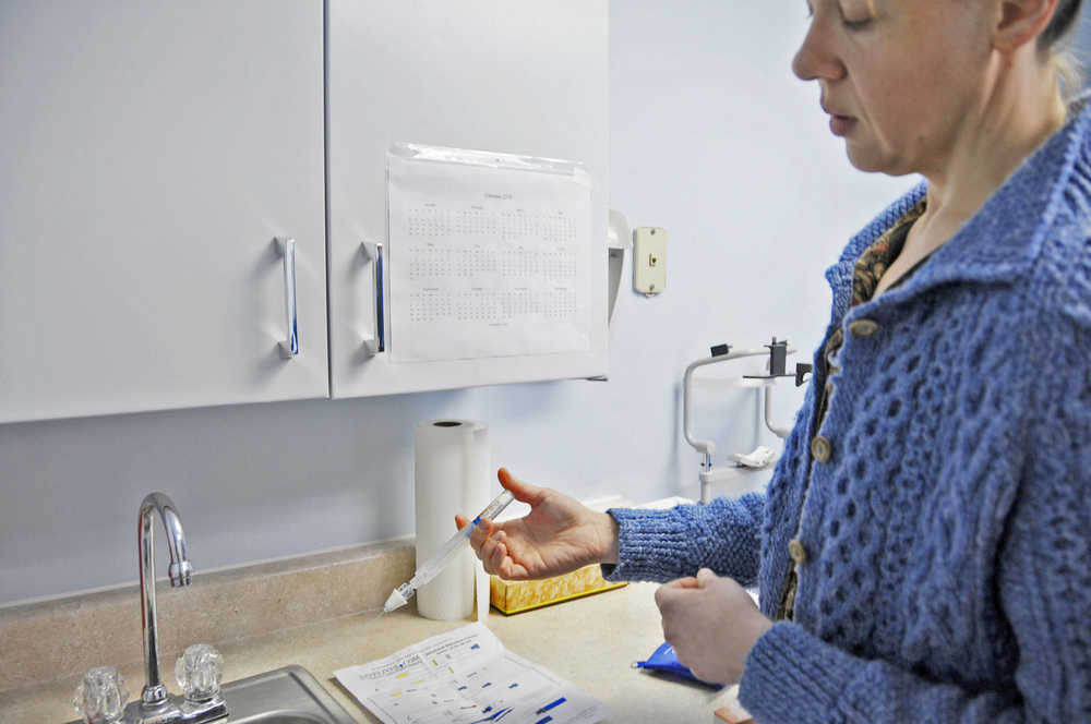 Photo by Elizabeth Earl/Peninsula Clarion Dr. Sarah Spencer of the Ninilchik Community Clinic demonstrates how to equip a vial of naloxone, an overdose rescue medication, into an injectable pen. She sends many of her opiate addict patients home with one in case of an emergency.