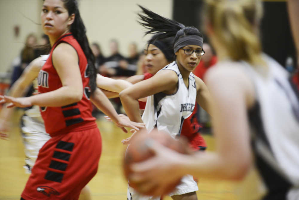 Photo by Kelly Sullivan/ Peninsula Clarion Nikiski Bulldog Arianne Parrish makes sure she is accessible to her team mate during the game against the Houton High School Hawks, Saturday, Jan. 17, 2015, at Nikiski Middle-High School in Nikiski, Alaska.