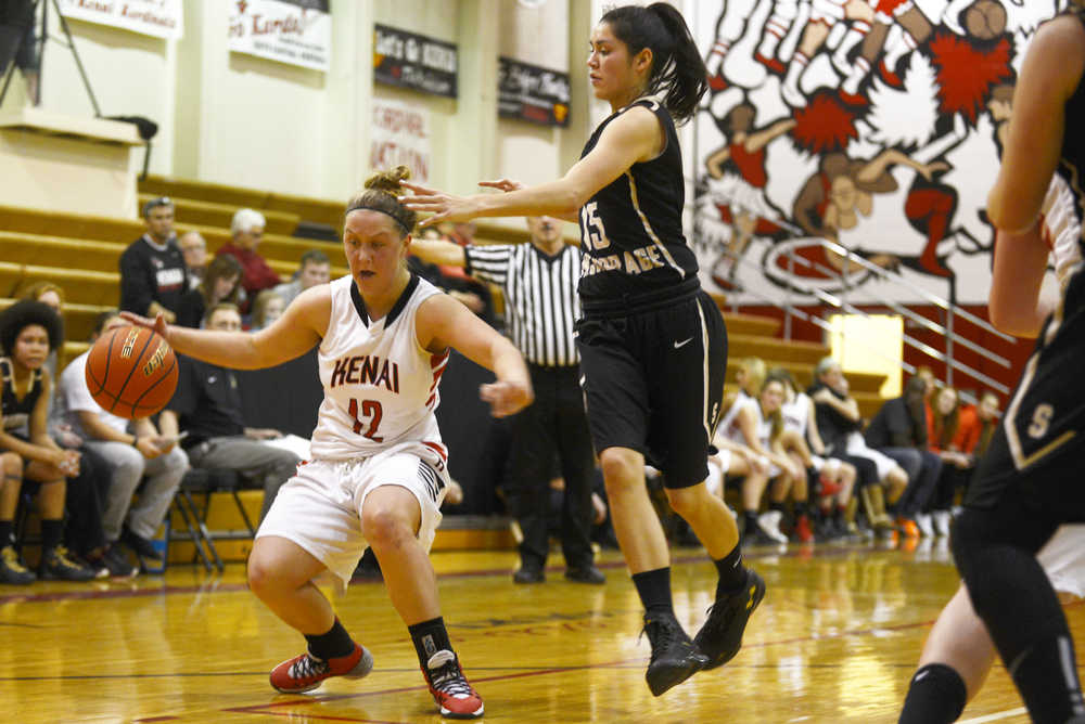 Ben Boettger/Peninsula Clarion Kenai Central High School basketball player Hannah Drury keeps the ball from South Anchorage's Kelsey Sweetsir during a game on Friday, Dec. 18 in Kenai.