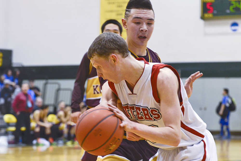 Photo by Rashah McChesney/Peninsula Clarion  Seldovia's Aidan Philpot works his way around Kotlik's Juwan Akaran during their game at the 2015 March Madness Small Schools championships on Saturday March 14, 2015 in Anchorage, Alaska.