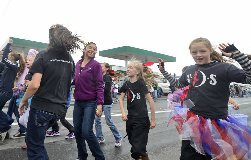 Photo by Rashah McChesney/Peninsula Clarion  Students from Vergine's Dance Studio jump around for the crowd during the annual Fourth of July parade in 2013 in Kenai, Alaska.