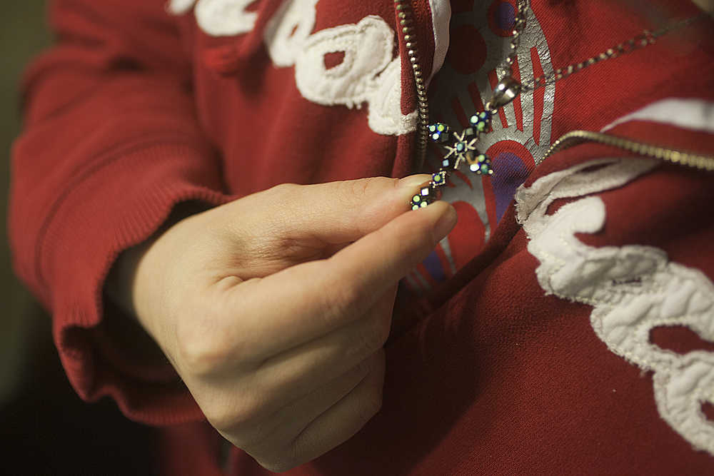 Photo by Rashah McChesney/Peninsula Clarion Nicole Harmon fiddled with a cross that belonged to her mother during an interview about her life following two traumatic events, one a car accident the other a sudden and catastrophic stroke.