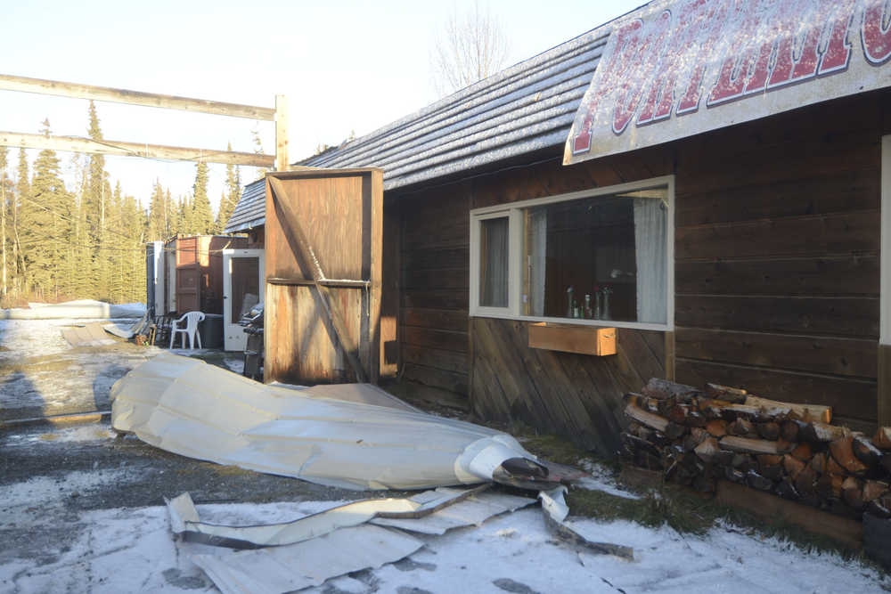Photo by Megan Pacer/Peninsula Clarion The strips of metal roofing cover the gound on Thursday, Dec. 31, 2015 outside Porterhouse Grill in Sterling, Alaska, after a wind storm stripped a large section of the roof off and caused water damage inside.