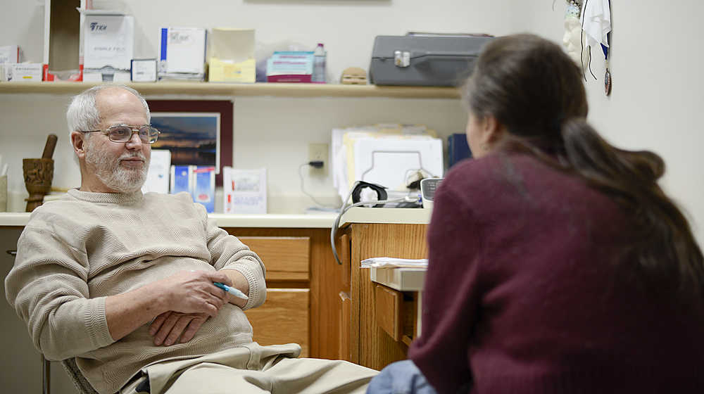 Photo by Rashah McChesney/Peninsula Clarion Dr. Michael Merrick talks to a patient about her addiction as she comes in to get her perscription to Suboxone, a medicine used to treat opioid addictions, on Dec. 23, 2015 in Merrick's office in Kenai, Alaska. Kenai Peninsula doctors wrangle with access and treatment for opoid addicts.