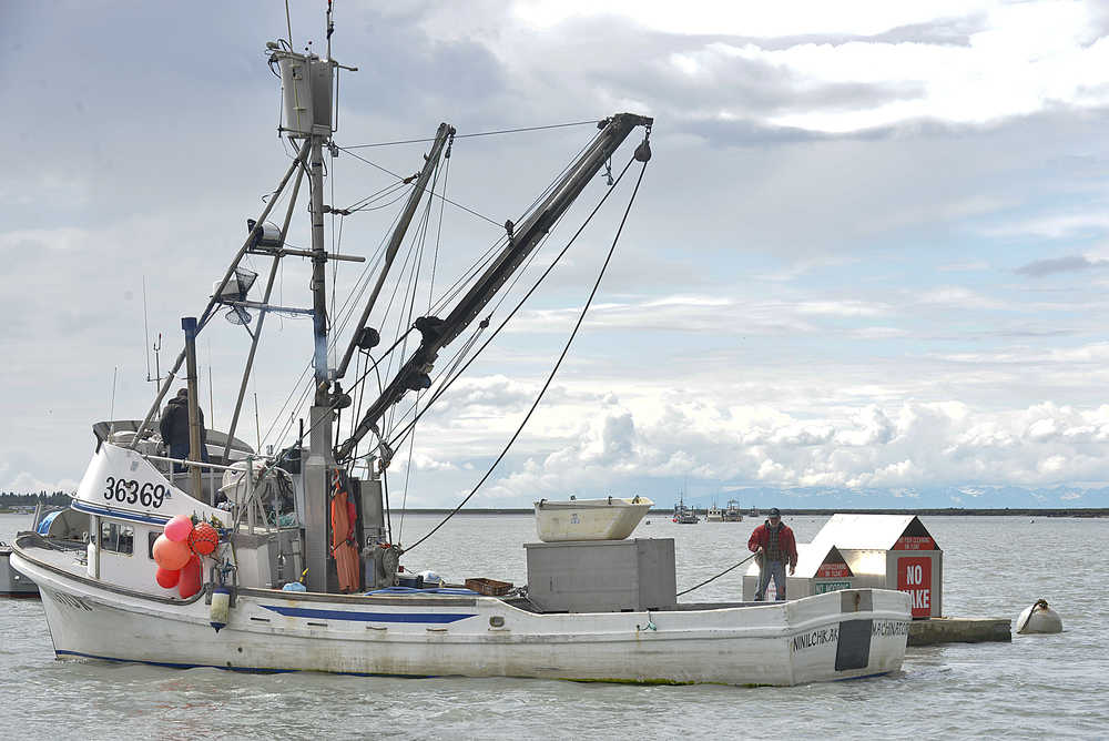 Photo by Rashah McChesney/Peninsula Clarion Two men prepare to moor the fishing vessel Machinator on the Kenai River near the Kenai City Docks on Tuesday June 30, 2015 in Kenai, Alaska.