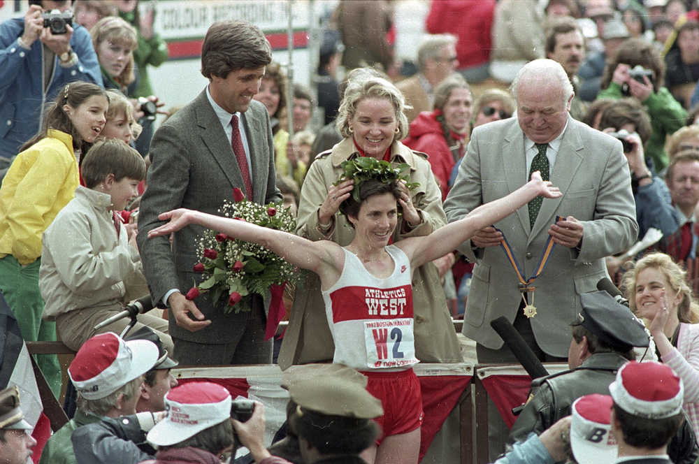 FILE - In this April 19, 1983, file photo, Joan Benoit receives her laurel wreath and reacts to cheering crowds after winning the Boston Marathon in record time for the women's division, in Boston. Massachusetts Lt. Gov. John Kerry, left in red tie, stands behind her. Benoit also won the women's division of the race in 1979. The first feature-length documentary film highlighting historical moments of the nation's oldest marathon is in the works, tentatively set to premiere in April 2017 in conjunction with the 121st running of the race.  (AP Photo/File)
