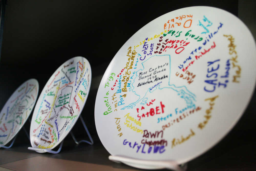 Photo by Kelly Sullivan/ Peninsula Clarion Lucretia Carter taught second grade in Kenai and Soldotna for two decades and each year had her students design and give their signatures onto a medium that was later made into a commemorative plate, photographed above Friday, Jan. 8, 2016, at the Joyce K. Carver Memorial Library in Soldonta, Alaska. The entire collection is on display through the end of February.