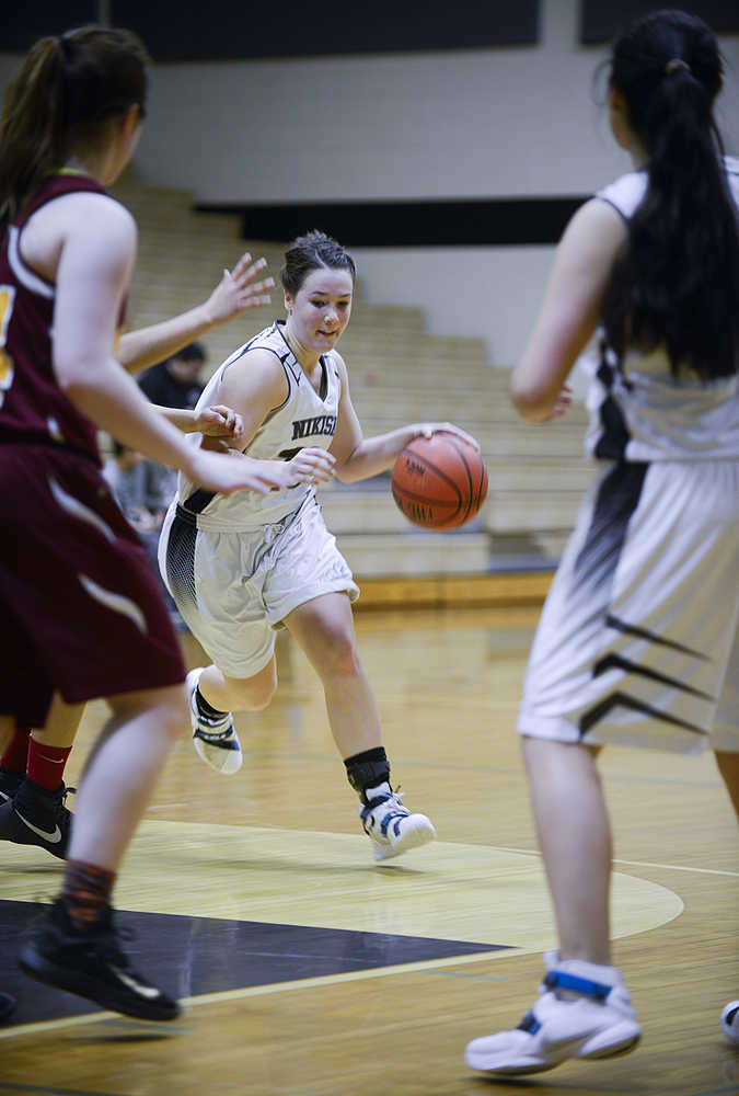 Photo by Rashah McChesney/Peninsula Clarion Nikiski's Hallie Riddall dodges around a Mt. Edgecumbe player during their game on Saturday Jan. 9, 2015 in Nikiski, Alaska. Nikiski lost the game 63-24.