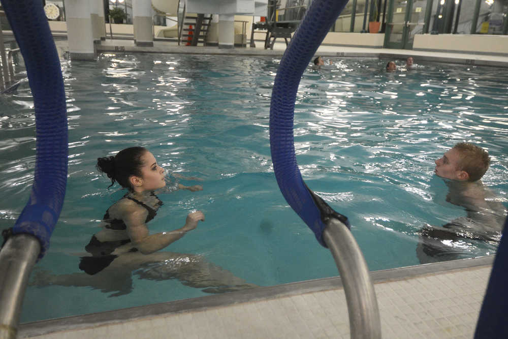 Photo by Megan Pacer/Peninsula Clarion Zykiah Cooney, 18, swims a 10-pound brick to the side of the Nikiski Pool as part of a drill on Monday, Jan. 11, 2016 in Nikiski, Alaska. She and a handful of others participated in pre-course exercises at the beginning of an American Red Cross Lifeguard class being taught by Pool Supervisor Nigel LaRiccia.