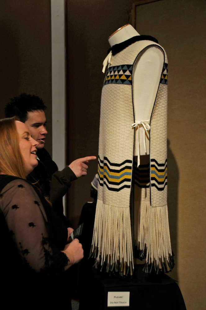 Photo by Elizabeth Earl/Peninsula Clarion Summer Parker (front) and Skye Lew (back) admire one of the tunics woven in the Ravenstail style, a type of weaving indigenous to the Pacific coast of Canada and Alaska. A display of multiple pieces woven by Juneau artist Kay Field Parker will be on display at the Kenai Visitors and Cultural Center for the winter and spring.