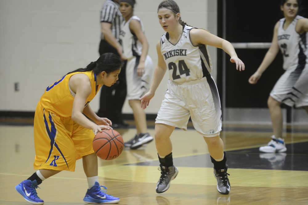 Photo by Jeff Helminiak/Peninsula Clarion Kodiak's Rica Gongora dribbles against Nikiski's Kelsey Clark on Thursday at Nikiski High School.