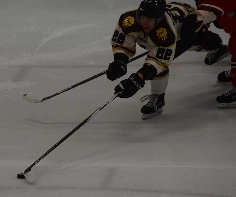 Photo by Jeff Helminiak/Peninsula Clarion Kenai River Brown Bears forward Joey Sardina uses his long reach to try and secure the puck Friday against the Minnesota Wilderness at the Soldotna Regional Sports Complex.