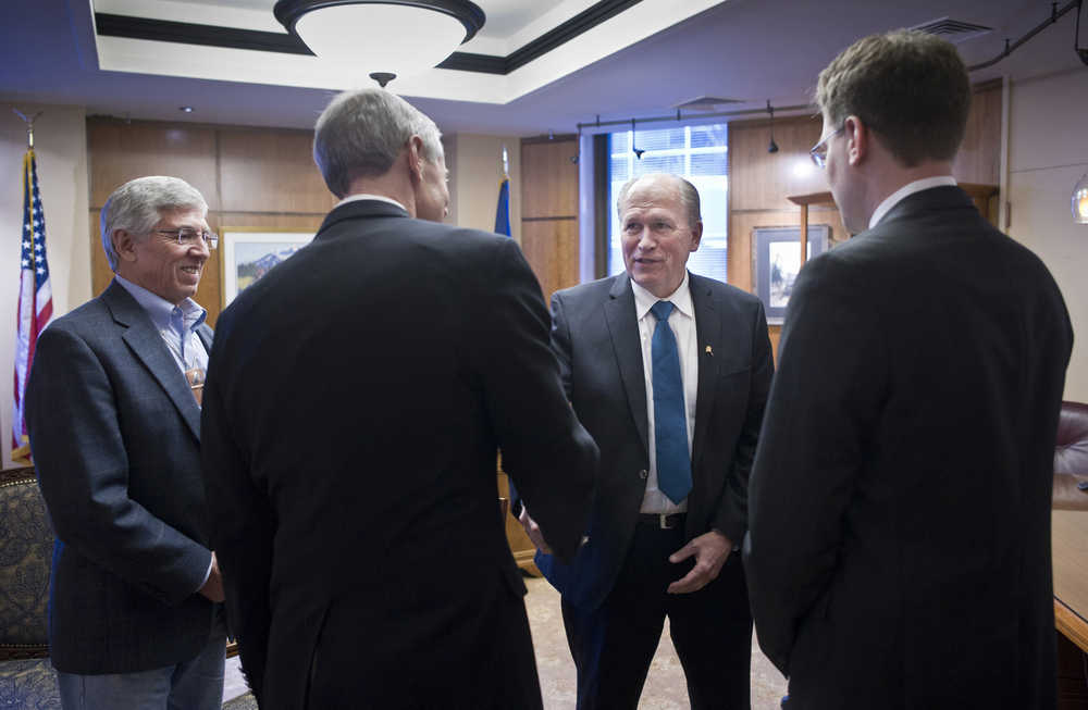 Gov. Bill Walker and Lt. Gov. Byron Mallott, left, receive a ceremonial visit by Rep. Matt Claman, D-Anchorage, second from left, and Rep. Lance Pruitt, R-Anchorage, after the House gaveled into session on the first day of the 29th Legislature at the Capitol in Juneau on Tuesday.
