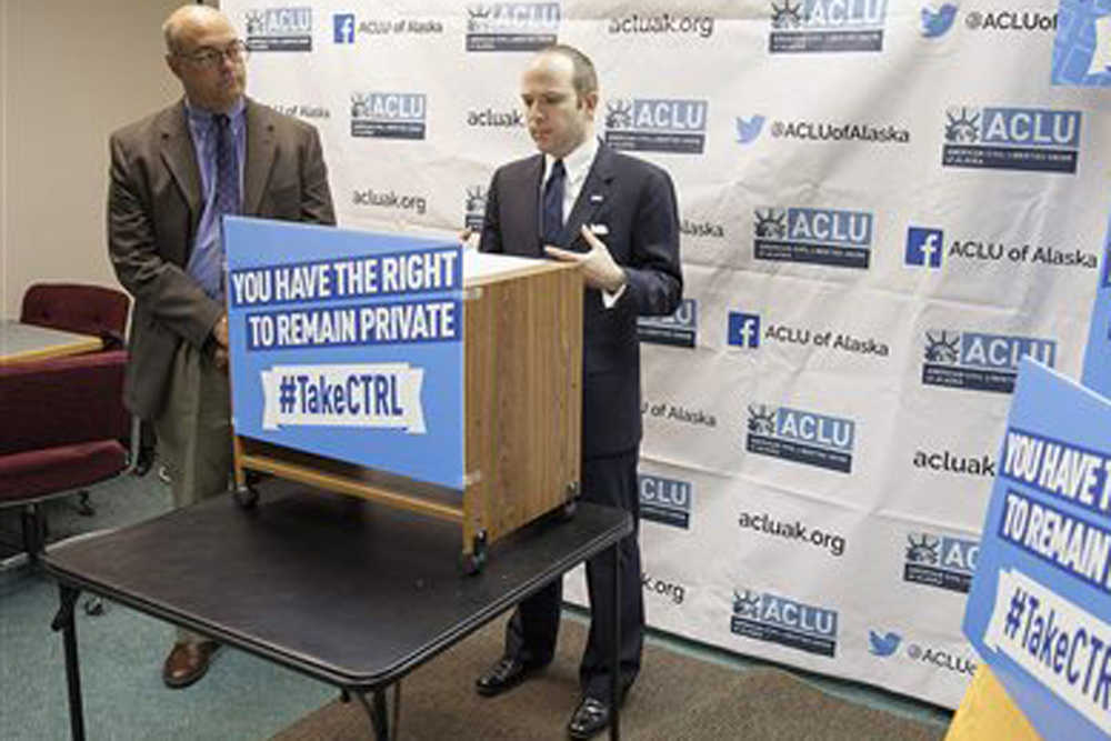 State Rep. Andy Josephson, R-Anchorage, left, listens as Joshua Decker, executive director of the American Civil Liberties Union of Alaska, speaks about two bills on data privacy at a news conference in in Juneau, Alaska, Wednesday Jan. 20, 2016. The bills are aimed at protecting students and employees from having to provide access to personal social media accounts under coercion or threat. (AP Photo/Rashah McChesney)
