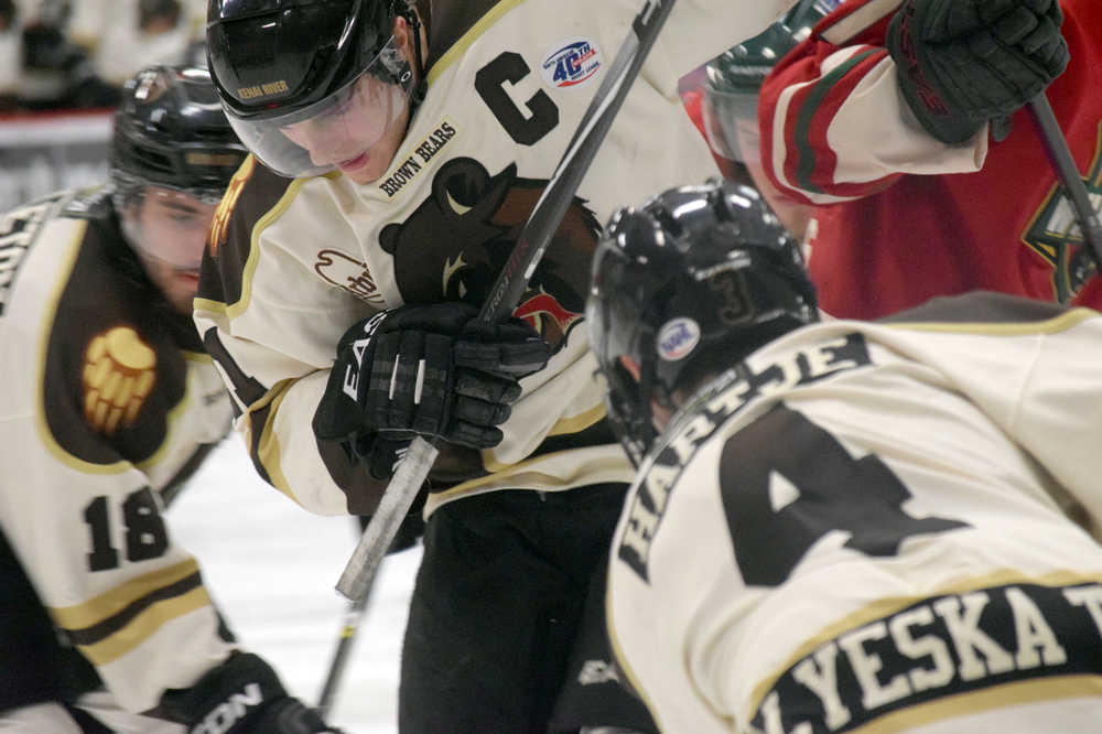 Photo by Jeff Helminiak/Peninsula Clarion Kenai River Brown Bears captain Adam Kresl battles for the puck Jan. 15 against the Minnesota Wilderness at the Soldotna Regional Sports Complex.