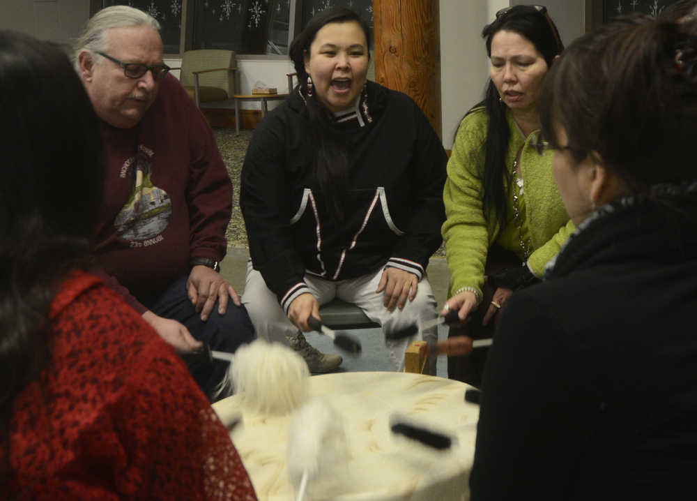 Photo by Megan Pacer/Peninsula Clarion Area residents take turns performing healing songs on a drum during a gathering called "You and Me" on Wednesday, Jan. 20, 2016 at the Dena'ina Wellness Center in Kenai, Alaska. The gatherings are held periodically to support those affected by suicide or loss.